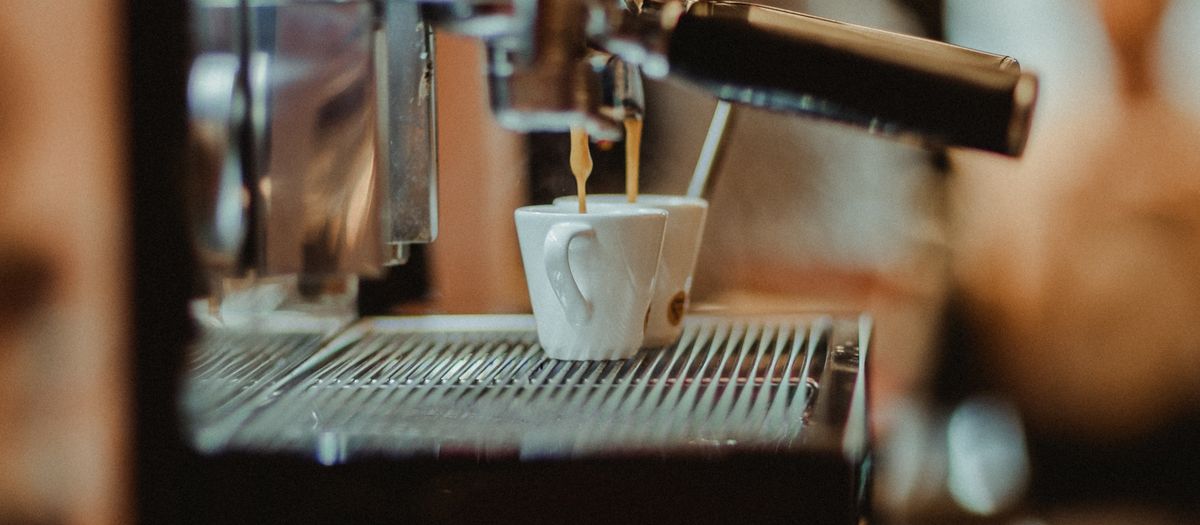 A home espresso machine with a steam wand and group head.